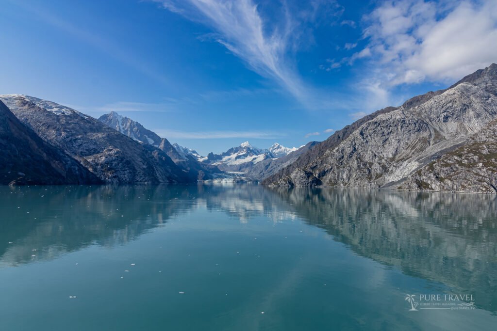 Scenic view of Margerie Glacier calving into the water in Glacier Bay National Park, Alaska, during an August cruise